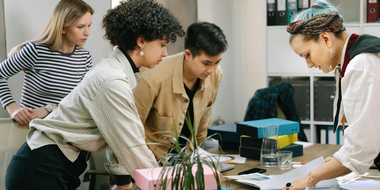 A diverse team of colleagues collaborating on a business project in a modern office setting.